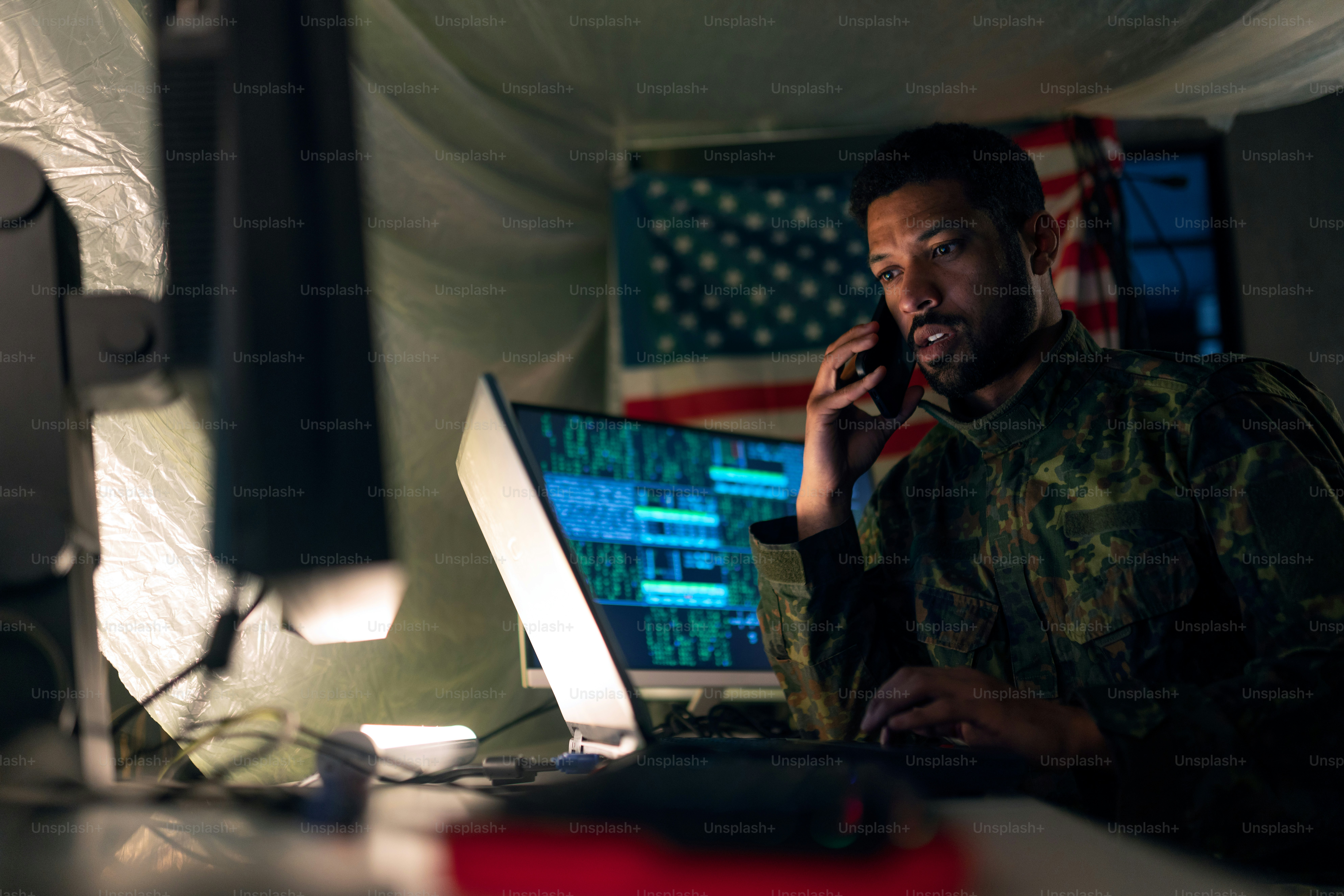An American hacker in military unifrorm on dark web, cyberwar concept.